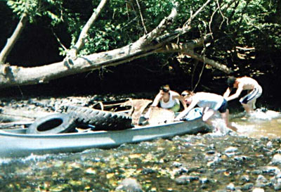 Pulling canoe loaded with tires out of the Rappahannock River